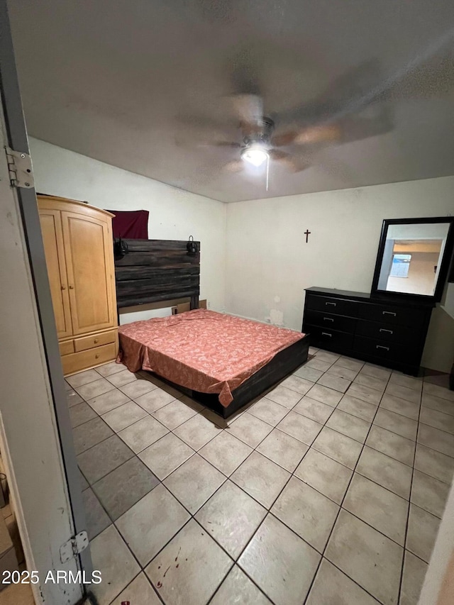 unfurnished bedroom with a textured ceiling, ceiling fan, and light tile patterned flooring