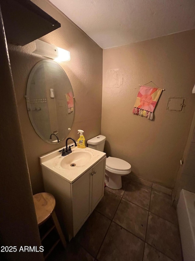 bathroom featuring toilet, vanity, and tile patterned floors