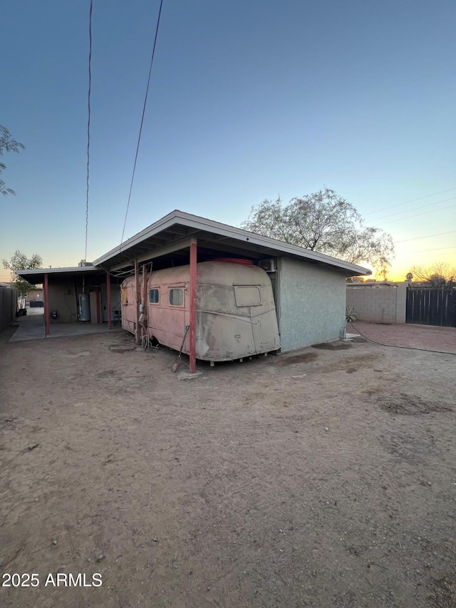 view of garage at dusk