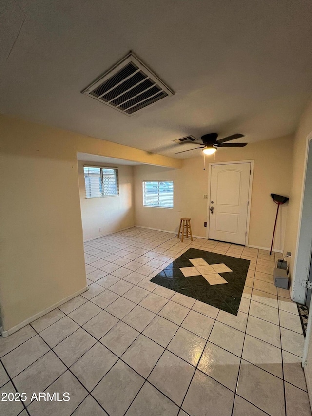 tiled foyer entrance featuring ceiling fan