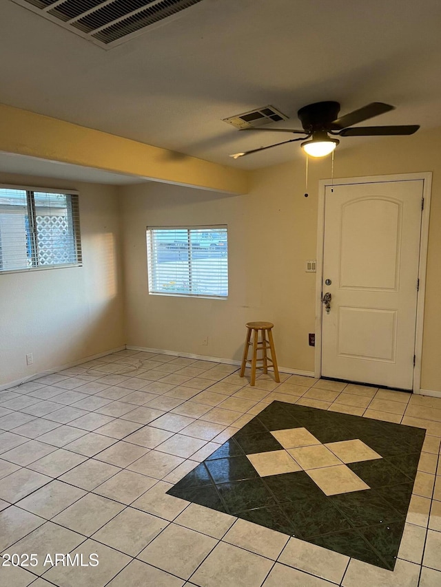 foyer with ceiling fan and light tile patterned floors