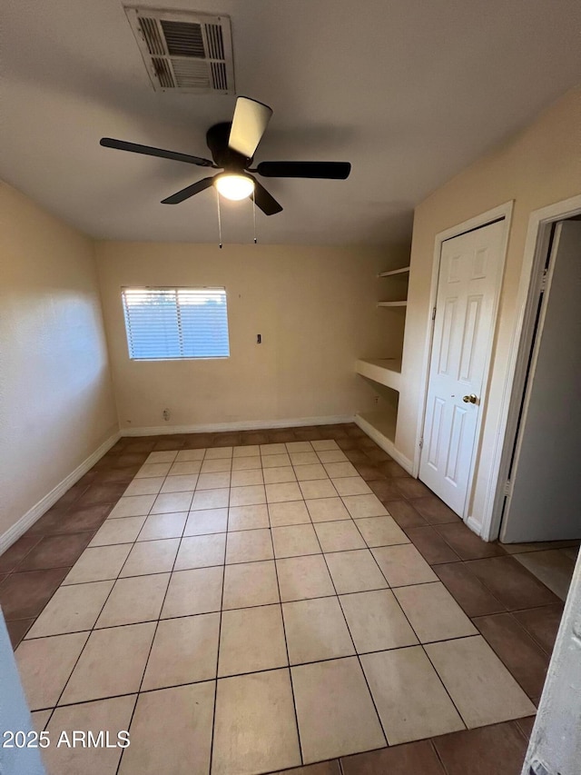 tiled empty room with ceiling fan