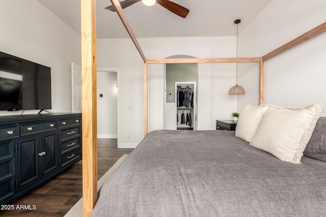 bedroom featuring a closet, a ceiling fan, baseboards, and dark wood-style floors