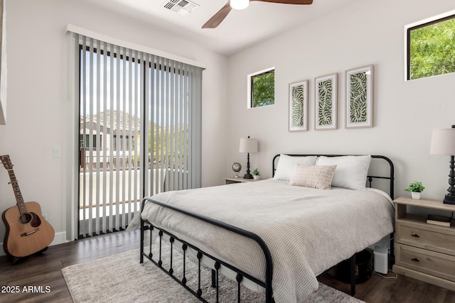 bedroom featuring visible vents, a ceiling fan, dark wood-style flooring, and access to exterior
