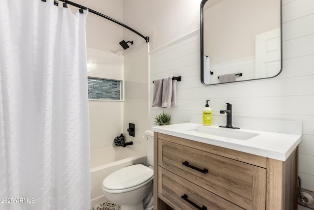 full bathroom with vanity, shower / bath combo, and toilet