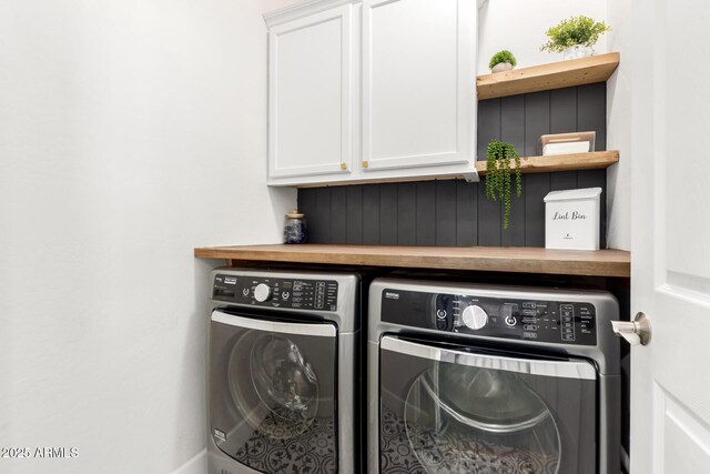 laundry area featuring cabinet space and washing machine and clothes dryer
