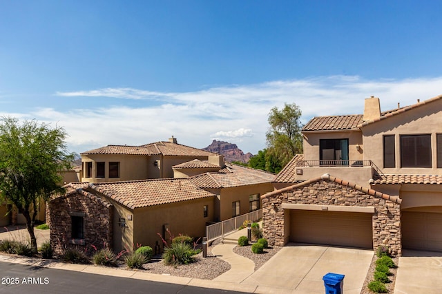 7445 E Eagle Crest Dr Unit 1145, Mesa, AZ 85207 - mediterranean / spanish house with driveway, a tile roof, stone siding, and stucco siding