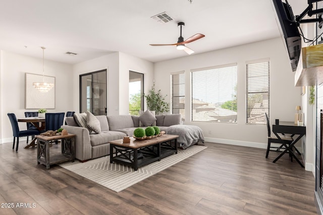living area with visible vents, baseboards, and a wealth of natural light