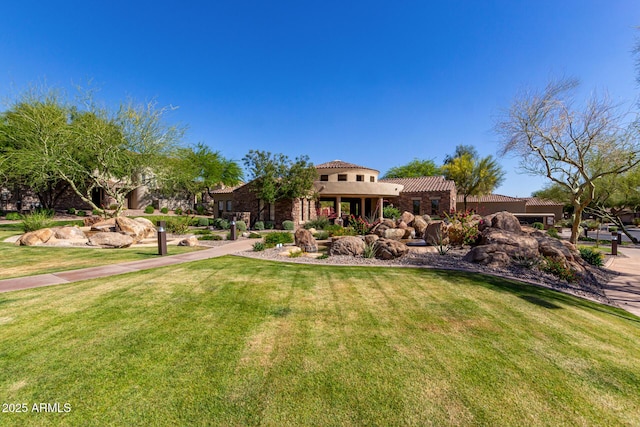7445 E Eagle Crest Dr Unit 1145, Mesa, AZ 85207 - mediterranean / spanish-style home with stucco siding, a tile roof, and a front lawn