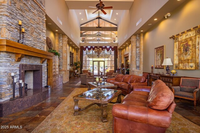 7445 E Eagle Crest Dr Unit 1145, Mesa, AZ 85207 - living area with stone tile floors, visible vents, ceiling fan with notable chandelier, and a towering ceiling