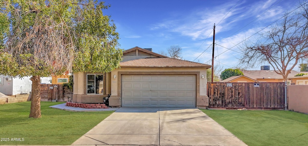 view of front of home featuring a garage and a front lawn