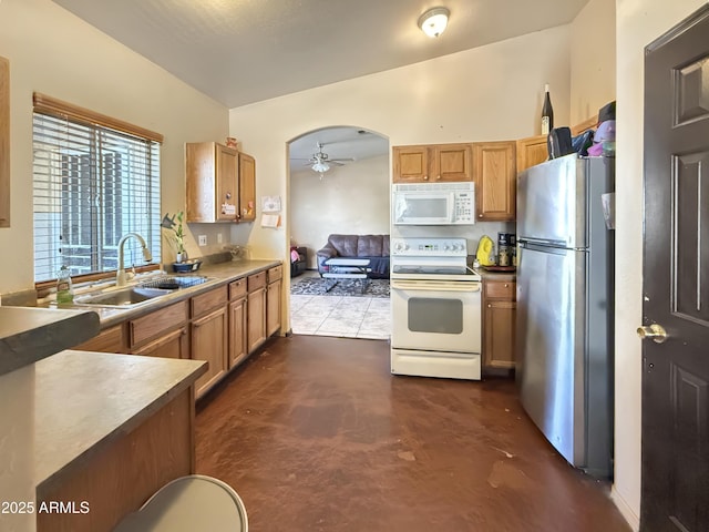 kitchen featuring ceiling fan, white appliances, and sink