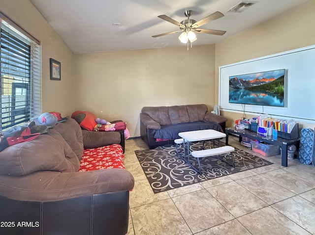 tiled living room with ceiling fan