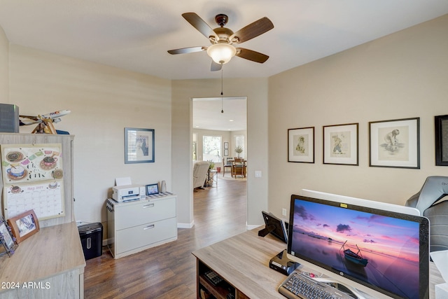 office with dark hardwood / wood-style flooring and ceiling fan