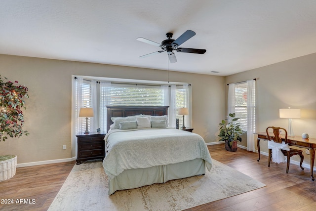 bedroom with ceiling fan and wood-type flooring