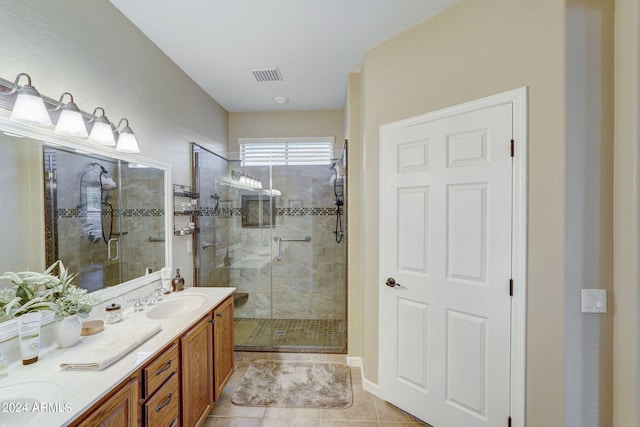 bathroom with vanity, tile patterned flooring, and a shower with door