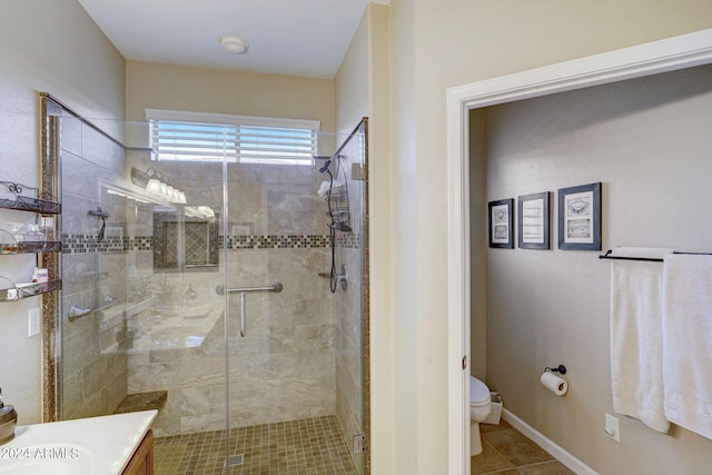 bathroom featuring vanity, toilet, tile patterned flooring, and a shower with door