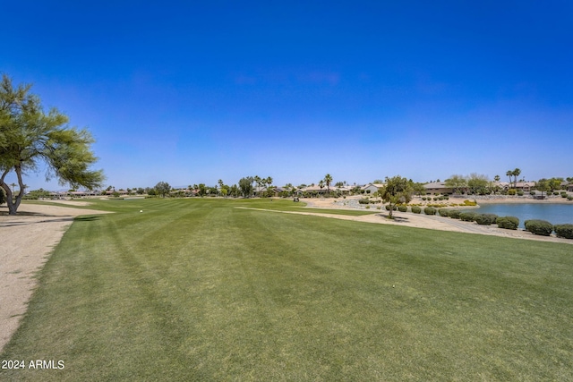 view of home's community featuring a water view and a lawn