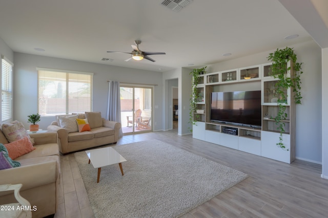 living room with ceiling fan and light hardwood / wood-style floors