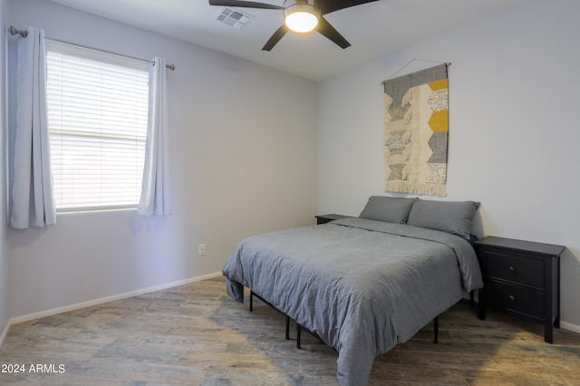 bedroom with wood-type flooring and ceiling fan