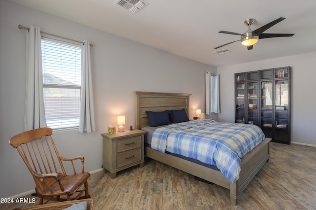 bedroom with wood-type flooring and ceiling fan