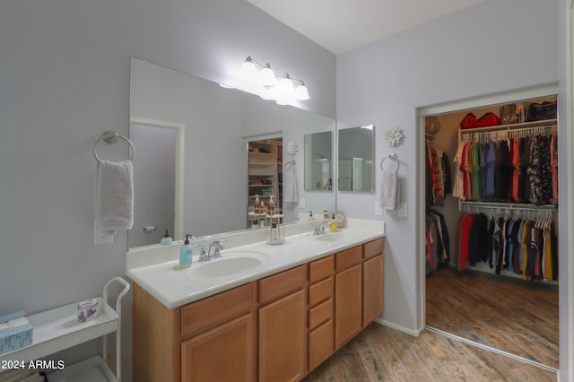 bathroom featuring hardwood / wood-style flooring and dual vanity