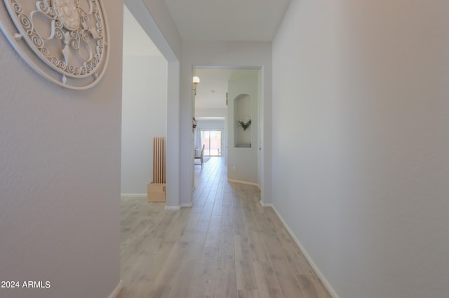 corridor with light hardwood / wood-style flooring