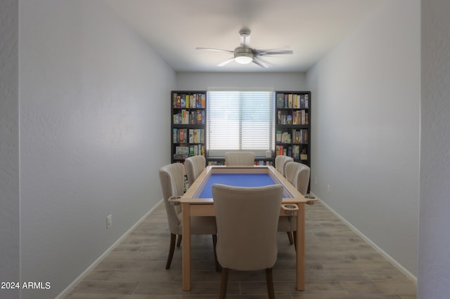 dining area featuring wood-type flooring and ceiling fan