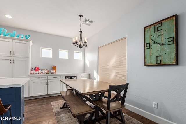 dining area with a notable chandelier and dark hardwood / wood-style flooring