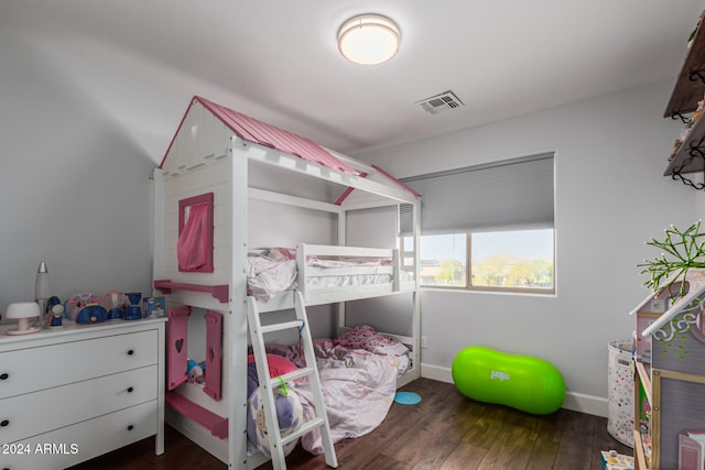 bedroom with dark hardwood / wood-style floors