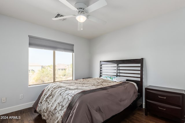 bedroom with ceiling fan and dark hardwood / wood-style flooring