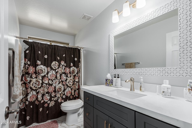 bathroom featuring tile patterned floors, vanity, and toilet