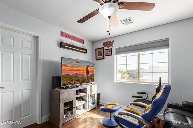 sitting room featuring ceiling fan and light wood-type flooring