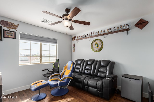 living room with ceiling fan and dark wood-type flooring