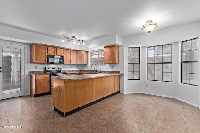 kitchen with light tile patterned flooring, sink, stainless steel range with electric cooktop, and kitchen peninsula