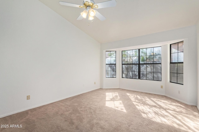 spare room featuring high vaulted ceiling, light colored carpet, and ceiling fan