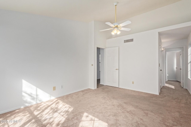 unfurnished room featuring vaulted ceiling, light colored carpet, and ceiling fan