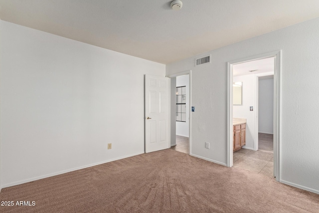 unfurnished bedroom featuring light carpet