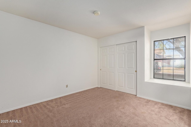 unfurnished bedroom with carpet floors and a closet