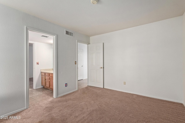 unfurnished bedroom featuring light carpet