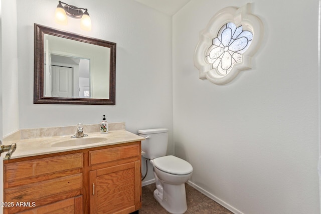 bathroom featuring vanity, tile patterned floors, and toilet