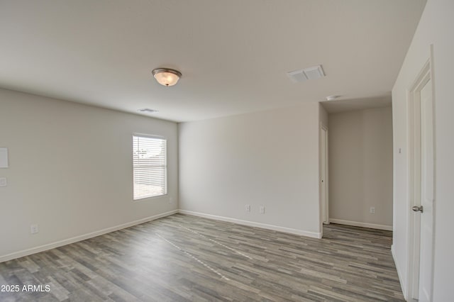 unfurnished room with hardwood / wood-style floors