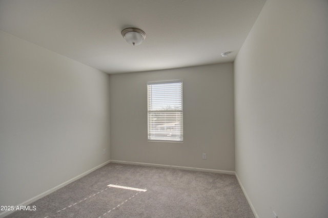 spare room with light colored carpet