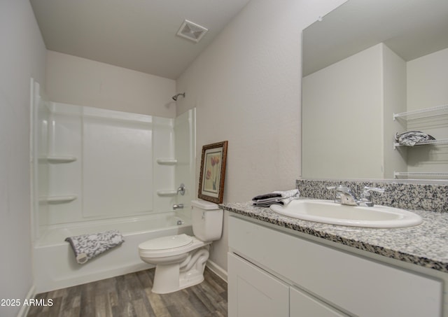 full bathroom featuring bathtub / shower combination, vanity, hardwood / wood-style flooring, and toilet