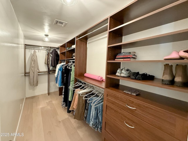 walk in closet with visible vents and light wood finished floors