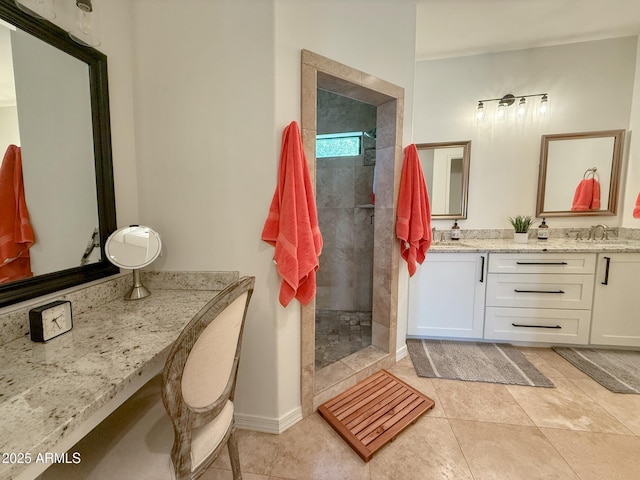 full bathroom with baseboards, double vanity, a sink, walk in shower, and tile patterned floors