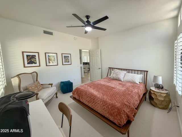 carpeted bedroom with baseboards, visible vents, and ceiling fan