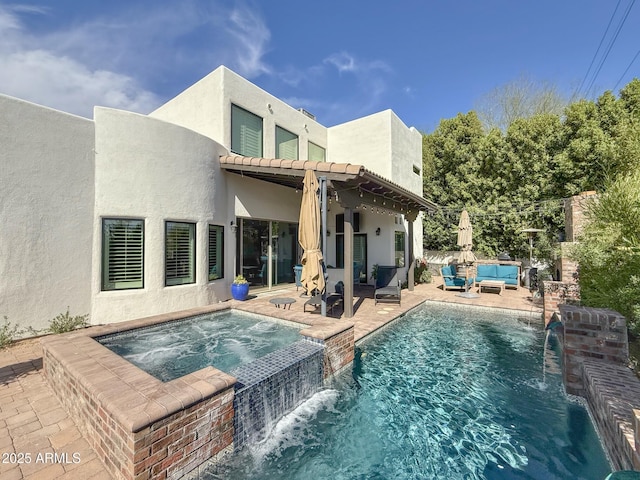 back of house featuring a pool with connected hot tub, a tile roof, stucco siding, an outdoor hangout area, and a patio area