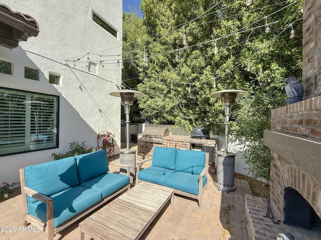 view of patio / terrace with an outdoor hangout area, a grill, and exterior kitchen