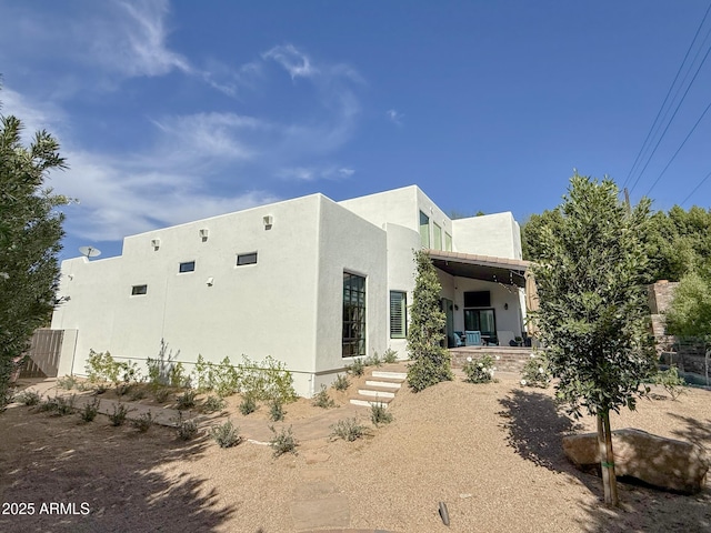 back of house with stucco siding